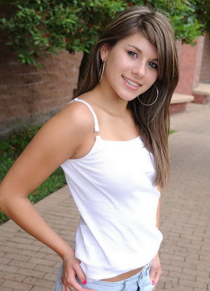 18 year old female Doris G slips off her underwear to pose naked on her bed